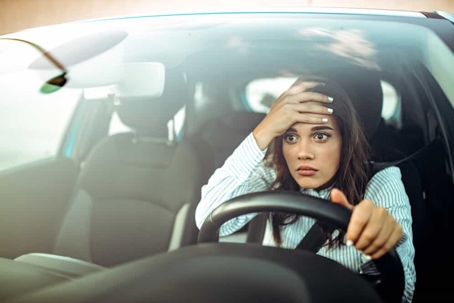Young woman is stressed out while driving