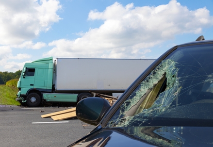 View of truck in an accident with car.