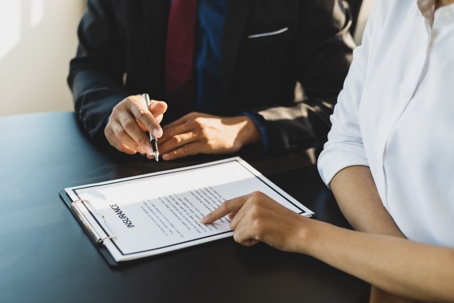 Woman pointing out details on insurance form